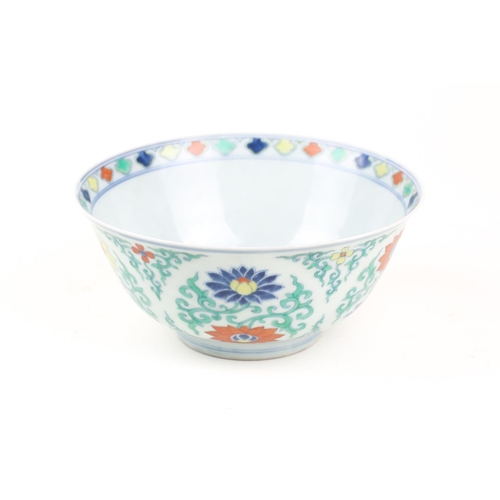 134 - A Chinese Doucai bowl, painted with blue, red & yellow lotus flowers, amongst green tendrils, apocry... 