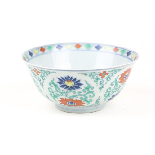 134 - A Chinese Doucai bowl, painted with blue, red & yellow lotus flowers, amongst green tendrils, apocry... 