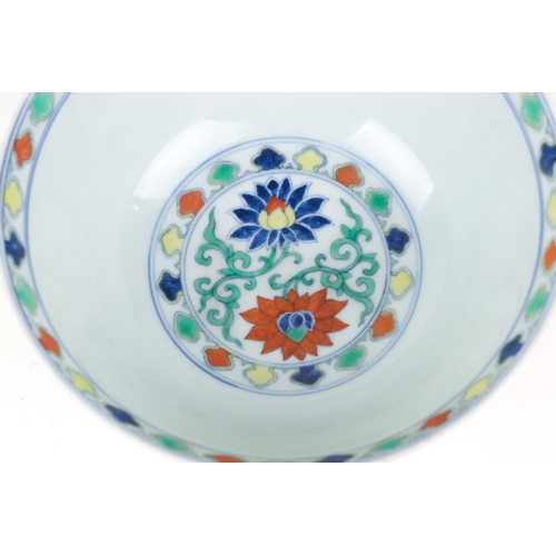 134 - A Chinese Doucai bowl, painted with blue, red & yellow lotus flowers, amongst green tendrils, apocry... 