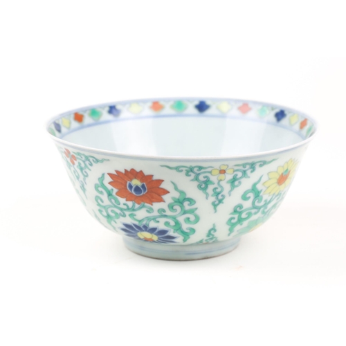 134 - A Chinese Doucai bowl, painted with blue, red & yellow lotus flowers, amongst green tendrils, apocry... 