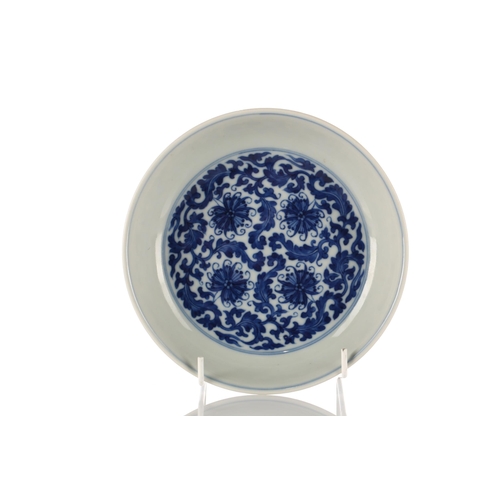 135 - A Chinese blue & white lotus dish, Qing, the interior painted with four lotus flowers amongst scroll... 