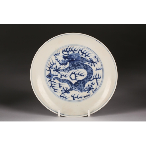 136 - A Chinese blue and white dragon saucer dish, the interior an exterior painted with dragons chasing a... 