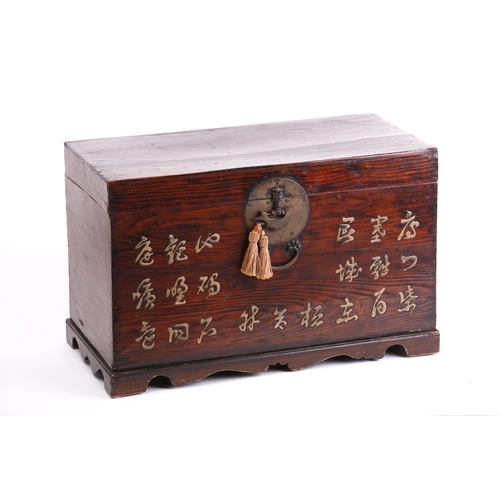 142 - A Korean elmwood blanket box 19th/20th century. With raised lacquer inscription and decorative brass... 