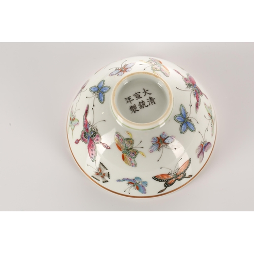 147 - A Chinese porcelain butterfly bowl, the interior painted with the eight trigrams bordering a Buddhis... 