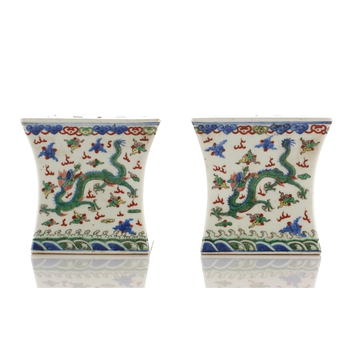 148 - A pair of Chinese porcelain Wucai stands, Republic period or later, of waisted square form, the top ... 