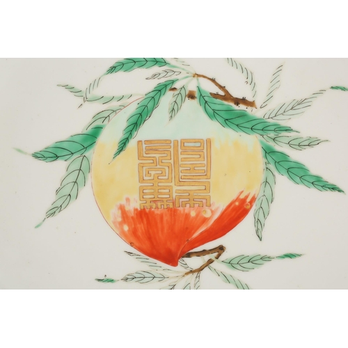 150 - A Chinese Famille Verte longevity dish, the centre painted with a peach on a leafy branch with gilt ... 