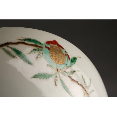 150 - A Chinese Famille Verte longevity dish, the centre painted with a peach on a leafy branch with gilt ... 