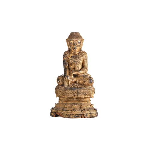 154 - A carved, lacquered and gilt wood figure of Buddha, seated in Bhumisparsha Mudra, on a stepped base ... 