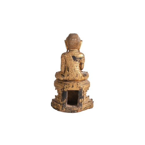 154 - A carved, lacquered and gilt wood figure of Buddha, seated in Bhumisparsha Mudra, on a stepped base ... 