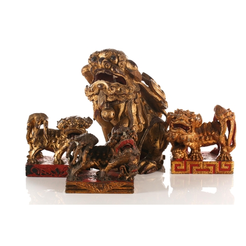 156 - A large carved and gilded wood temple lion, Qing late 19th/early 20th century, with scrolling mane a... 