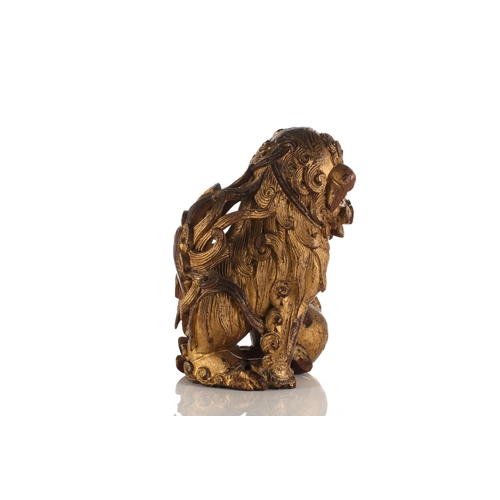 156 - A large carved and gilded wood temple lion, Qing late 19th/early 20th century, with scrolling mane a... 