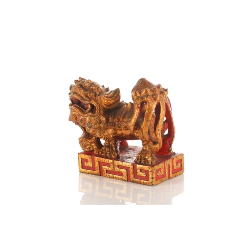 156 - A large carved and gilded wood temple lion, Qing late 19th/early 20th century, with scrolling mane a... 