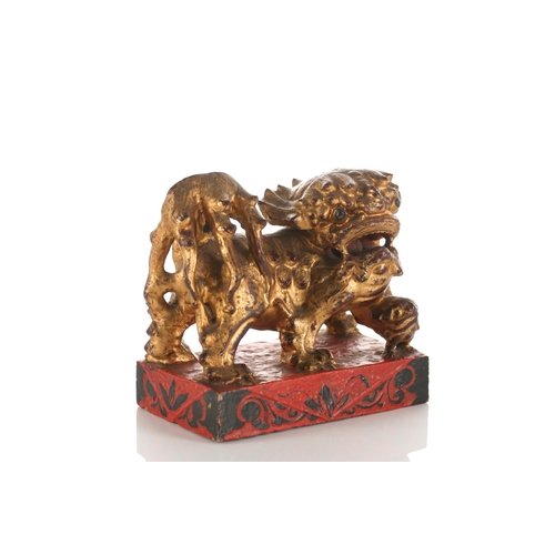 156 - A large carved and gilded wood temple lion, Qing late 19th/early 20th century, with scrolling mane a... 