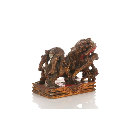 156 - A large carved and gilded wood temple lion, Qing late 19th/early 20th century, with scrolling mane a... 