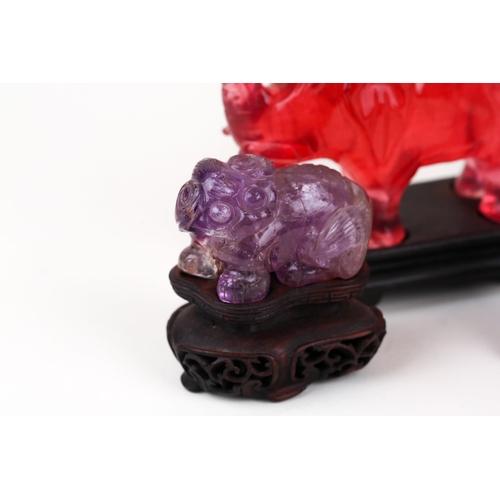 163 - A Chinese Jade amulet, carved and pierced with two opposing dragons, 8.7cm x 8cm, in wood stand, a C... 