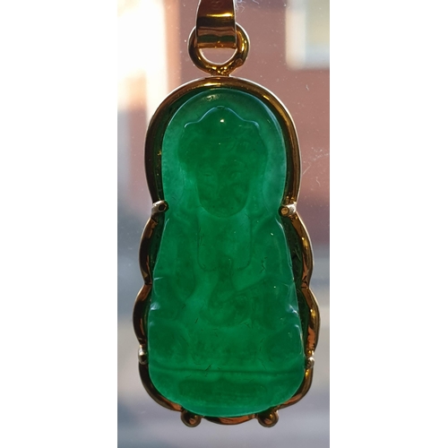 171 - An Eastern 18ct yellow gold and carved jadeite seated Buddha pendant. Marked 18K to the loop suspens... 