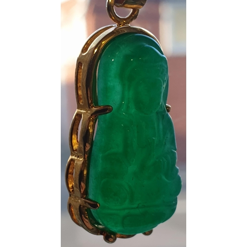 171 - An Eastern 18ct yellow gold and carved jadeite seated Buddha pendant. Marked 18K to the loop suspens... 