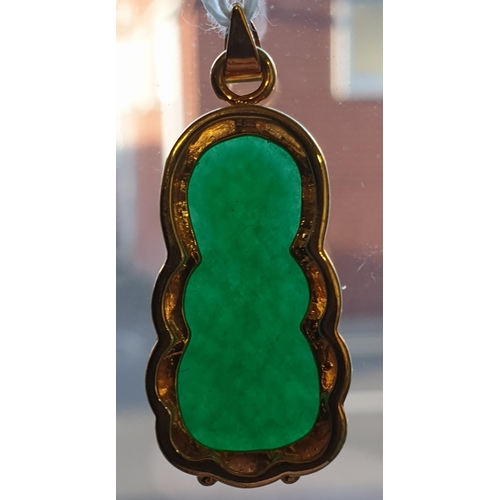 171 - An Eastern 18ct yellow gold and carved jadeite seated Buddha pendant. Marked 18K to the loop suspens... 