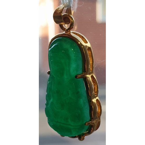 171 - An Eastern 18ct yellow gold and carved jadeite seated Buddha pendant. Marked 18K to the loop suspens... 