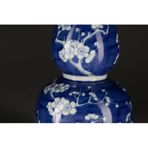 178 - A Chinese Huluping (double gourd) blue and white vase, painted with branches of blossoming prunus, a... 