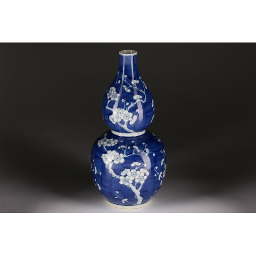 178 - A Chinese Huluping (double gourd) blue and white vase, painted with branches of blossoming prunus, a... 