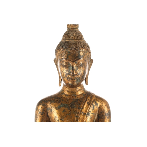 195 - A Thai gilt bronze figure of Buddha, 19th/20th century, seated in Bhumisparsha Mudra, with flaming u... 