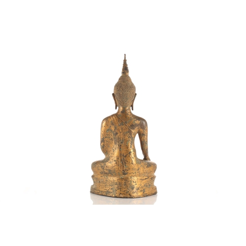 195 - A Thai gilt bronze figure of Buddha, 19th/20th century, seated in Bhumisparsha Mudra, with flaming u... 