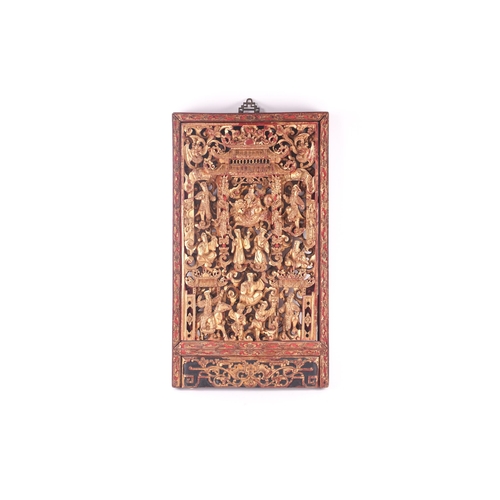 206 - A Chinese Chaozho carved giltwood panel, late Qing, early 20th century, the centre with a deity hold... 