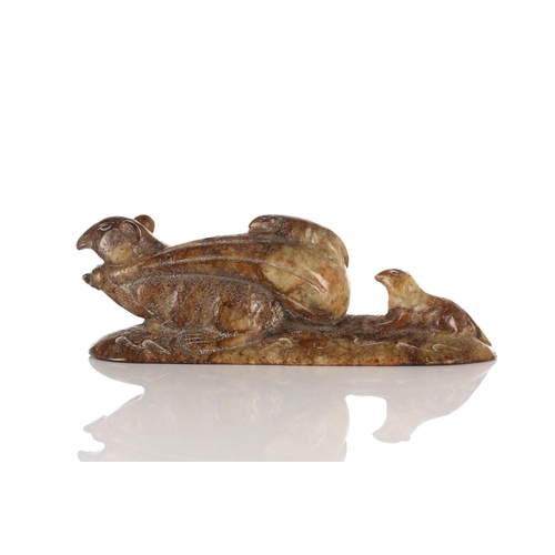 226 - A humorous Chinese carved jade figure of a rat, modelled with a large sack over its shoulder, a smal... 