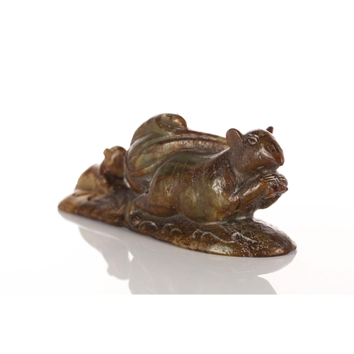 226 - A humorous Chinese carved jade figure of a rat, modelled with a large sack over its shoulder, a smal... 