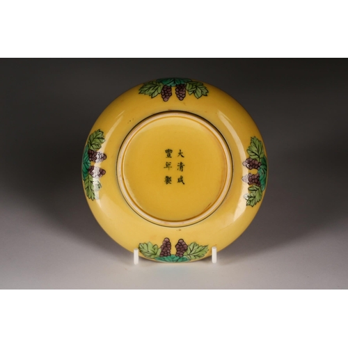 229 - A Chinese porcelain yellow grounf saucer, painted with green and aubergine dragons chasing a flaming... 