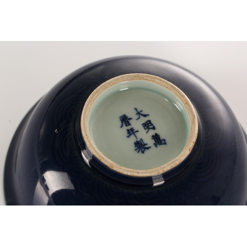 230 - A Chinese porcelain circular bowl with gross blue ground and everted rim decorated with anhau (secre... 