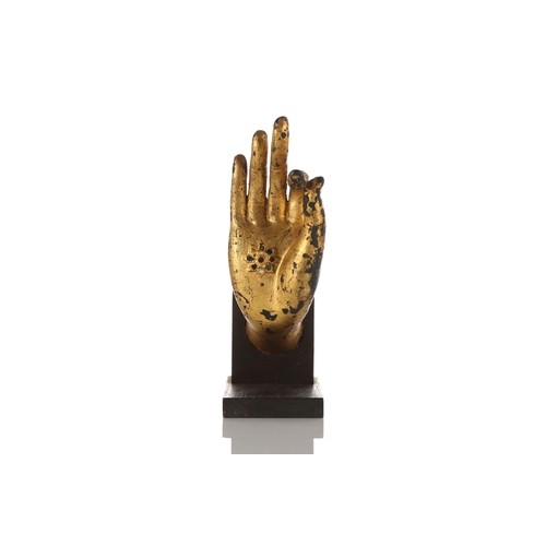 235 - A Thai gilt metal Buddha hand, modelled in Vitarka mudra, the palm inset with coloured glass jewels,... 