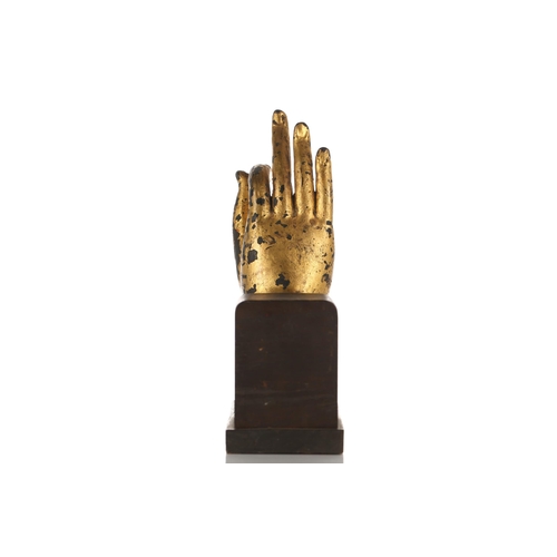 235 - A Thai gilt metal Buddha hand, modelled in Vitarka mudra, the palm inset with coloured glass jewels,... 