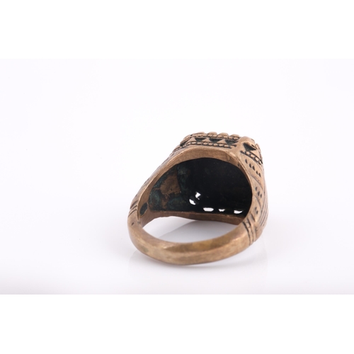 250 - A base metal Indo Persian gentleman's ring, engraved with calligraphic characters