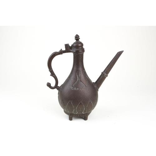 251 - An Indian Mughal brass ewer (Aftaba), 18th century or later, with hinged domed finial with pointed k... 