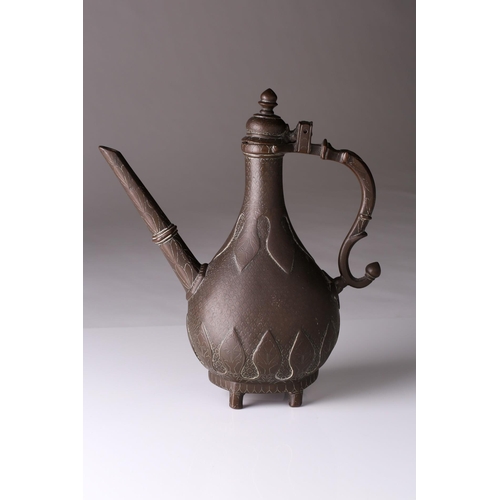 251 - An Indian Mughal brass ewer (Aftaba), 18th century or later, with hinged domed finial with pointed k... 