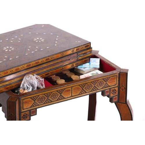 267 - A Damascus parquetry inlaid fold over gaming table,1920s. The rectangular top opens and rotates to r... 