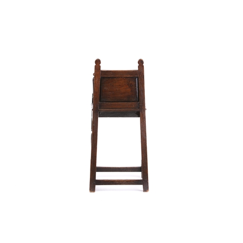 268 - A 17th-century style oak, child's joined high chair, with carved decoration, the shaped arms with tu... 