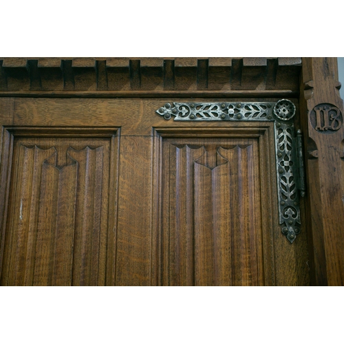 298 - A mid-19th century oak linen press by Gillows, based on designs by A.W.N. Pugin for the New Palace o... 