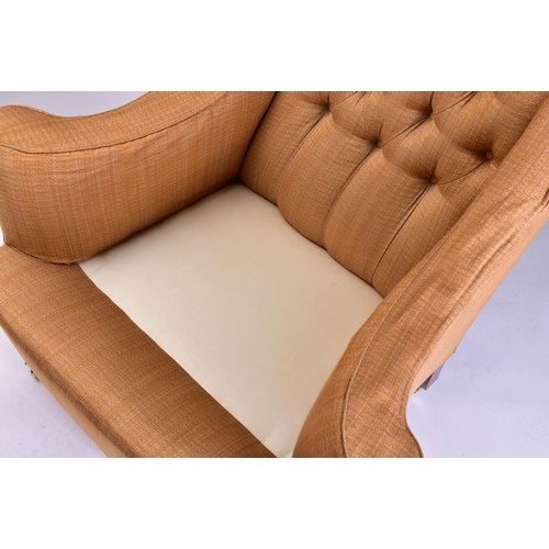 299 - A Howard Ltd upholstered armchair. 21st century, with shaped out swept arms and low, deep buttoned b... 