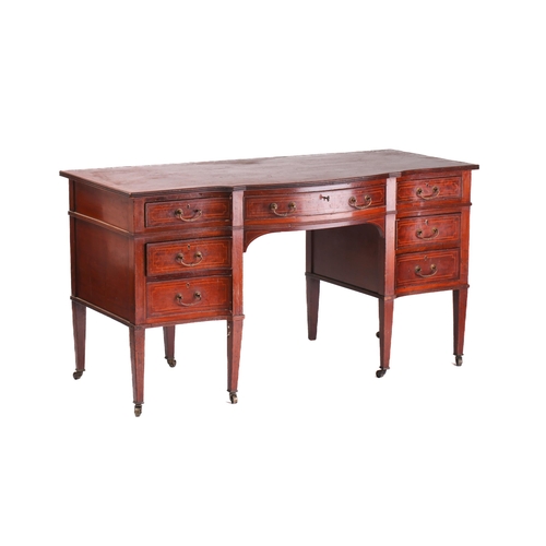 301 - An Edwardian inlaid mahogany serpentine kneehole dressing table, with crossbanded top and fitted six... 