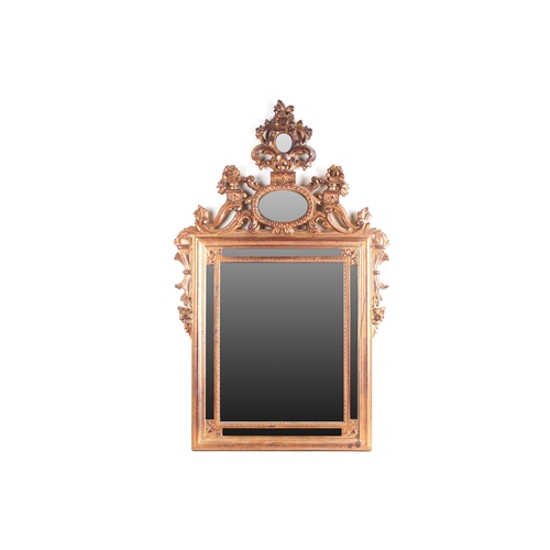 306 - A Florentine style carved and giltwood wall mirror, 20th century with a Neo-Classical frame, set wit... 