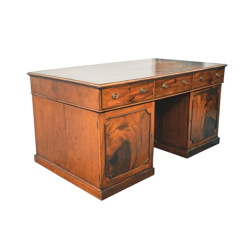 307 - A George IV figured mahogany kneehole partner's desk, with inset tooled tan hide inset and crossband... 