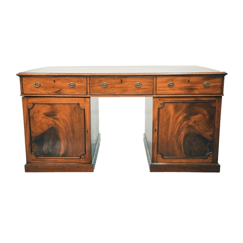 307 - A George IV figured mahogany kneehole partner's desk, with inset tooled tan hide inset and crossband... 