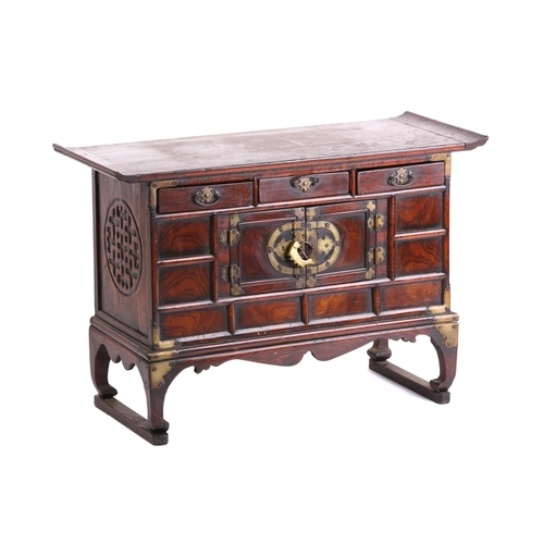 309 - A Chinese elm low cabinet, the first half of the 20th century, with everted top above three frieze d... 