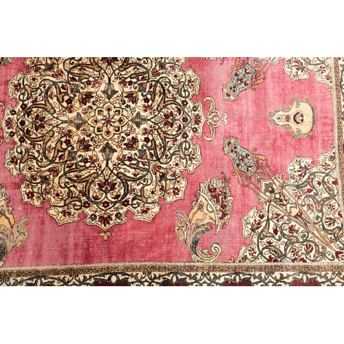 315 - A fine late 19th century /early 20th-century plum red ground silk Isfahan rug, with central barbed m... 