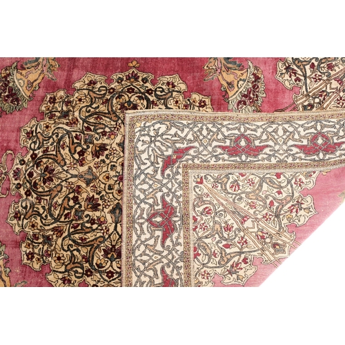 315 - A fine late 19th century /early 20th-century plum red ground silk Isfahan rug, with central barbed m... 