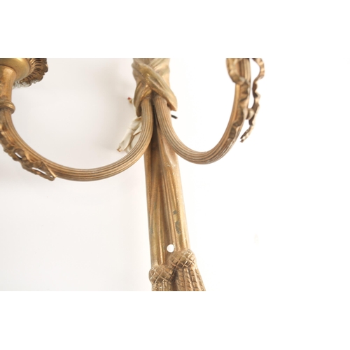 323 - A pair of Louis XVI style gilt brass wall sconces, 20th century, of tied cord form with faux hanging... 