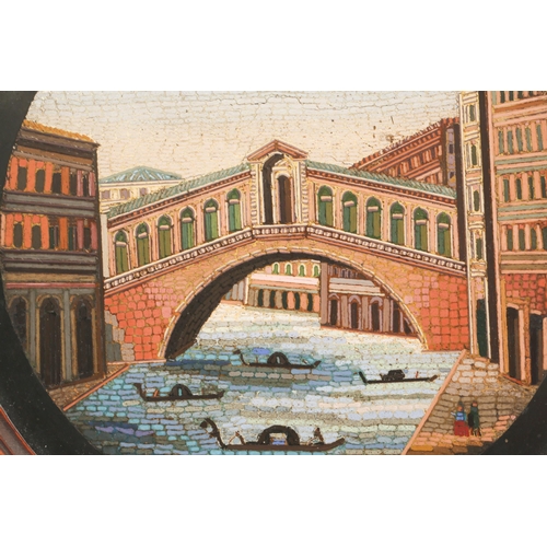 333 - A 19th century Grant Tour circular micro mosaic view of The Rialto Bridge, Venice, in a carved oak f... 